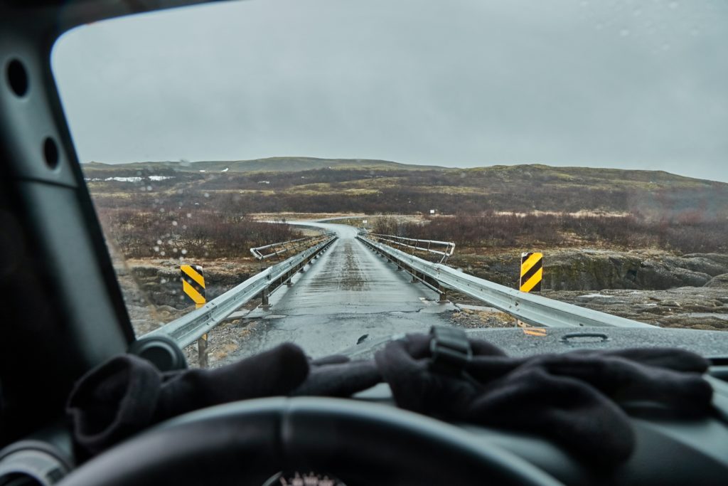 View from a car in Iceland crossing a single lane bridge, gloomy weather