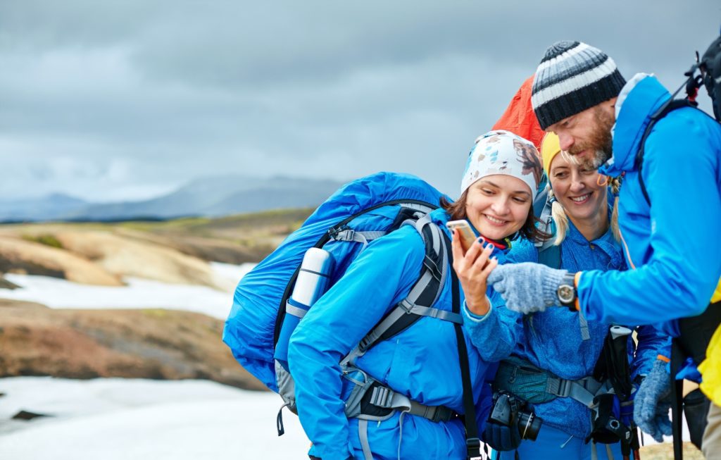 tourists taking photos in rhyolite mountains background in Iceland