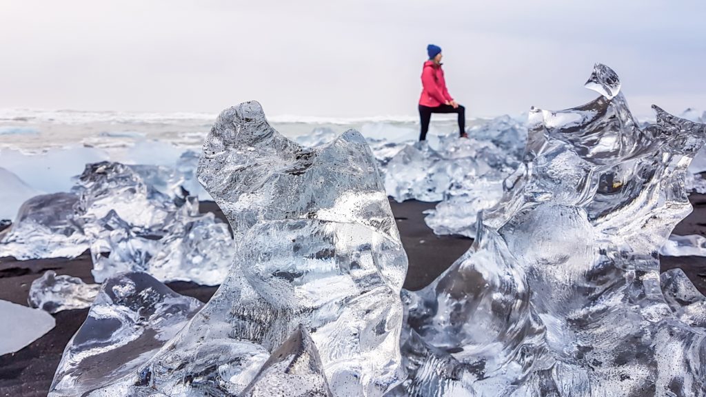A close up on an ice structure, laying on the black sand beach in Iceland, diamond beach