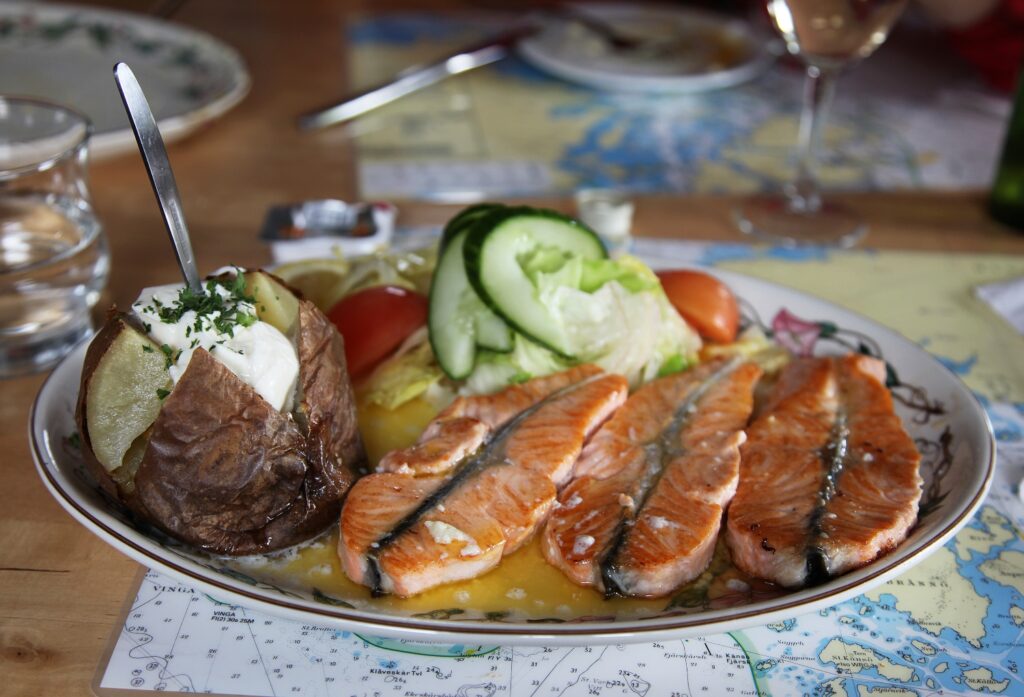 Traditional Icelandic dish with salmon steak and baked potatoes and vegetables