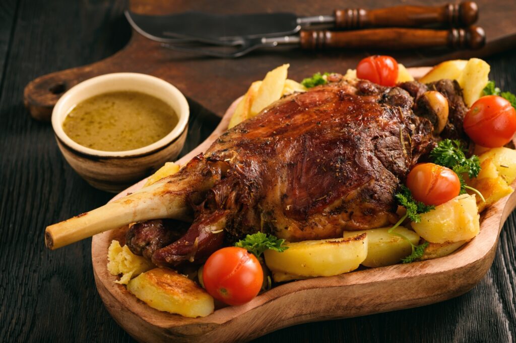 Slow baked lamb leg with potatoes and sauce