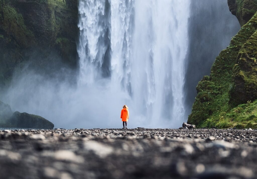 tourist and skogafoss waterfall in iceland